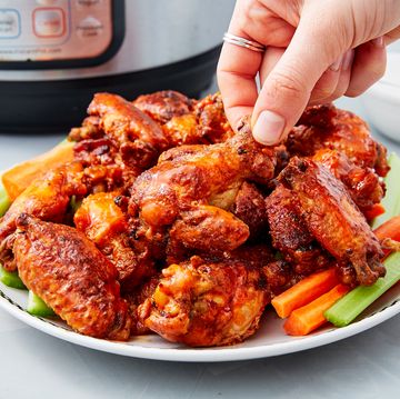 a pile of crispy instant pot chicken wings on top of crudite