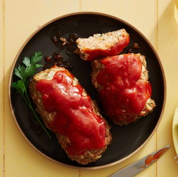 air fryer turkey meatloaf topped with ketchup on a black plate