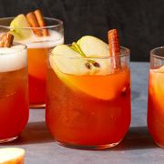 apple cider spritzes garnished with apples and cinnamon sticks