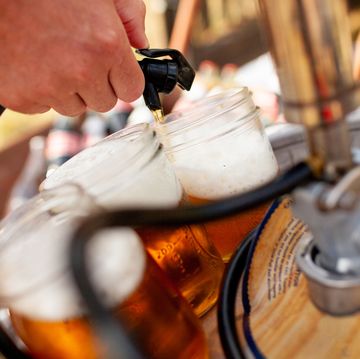 beer being pourn into mason jar from keg