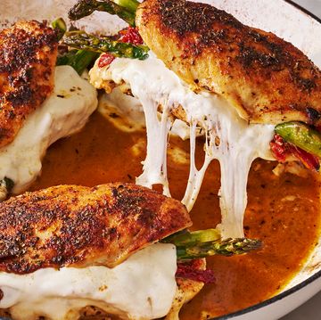 cheesy asparagus stuffed chicken in a white dutch oven