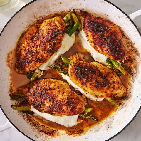 cheesy asparagus stuffed chicken in a white dutch oven