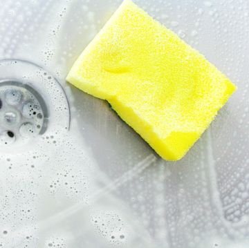 cleaning a sink with yellow sponge cleaning a sink with yellow sponge