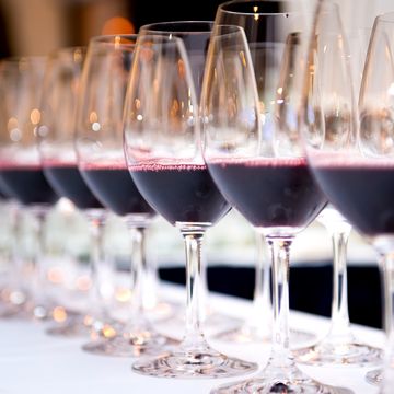 Close-Up Of Wineglass In Row On Table Close-Up Of Wineglass In Row On Table