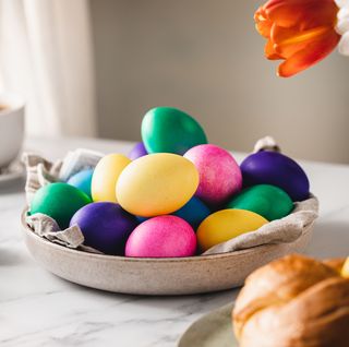 colorful easter eggs with cup of coffee on table