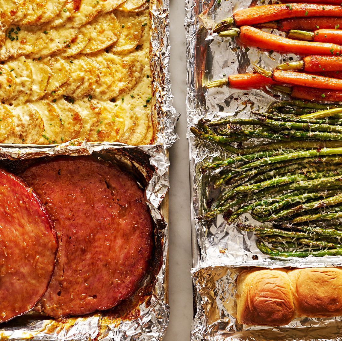sheet pan easter dinner with glazed ham, gruyere scalloped potatoes, roasted carrots, roasted asparagus, and rolls
