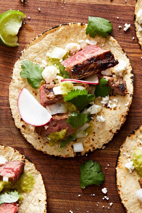 marinated, grilled skirt steak, piled into a corn tortilla with salsa verde, cilantro, red onion, cotija, and radish