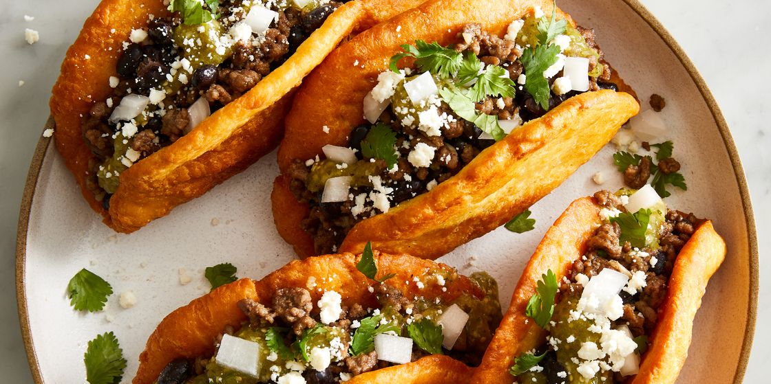 chalupas with ground beef beans onions cojita and salsa verde