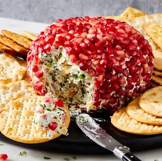 fancy christmas cheese ball covered in fresh pomegranate seeds