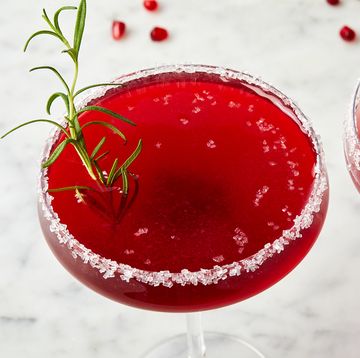 pomegranate martini in a glass with a sanding sugar rim