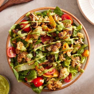 roasted cauliflower and mixed green and romaine salad topped with tomatoes, shaved carrots, and an avocado dressing