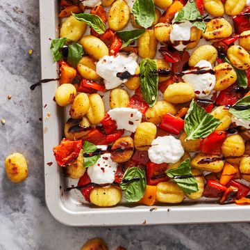 gnocchi, burrata, tomatoes, and basil drizzled with balsamic reduction on a sheet pan