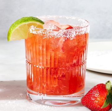 strawberry mezcal margarita with lime and strawberries