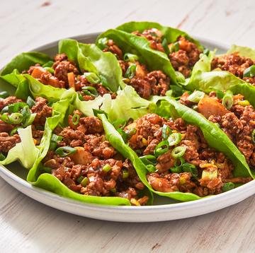 asian ground chicken lettuce wraps on a white plate